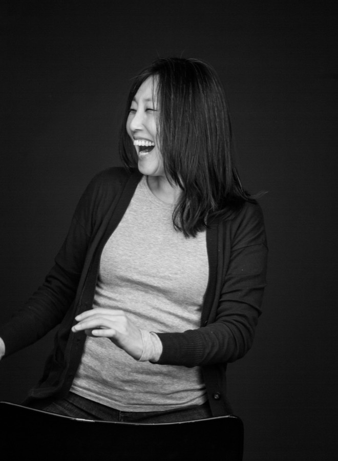 Black-and-white studio portrait, laughing