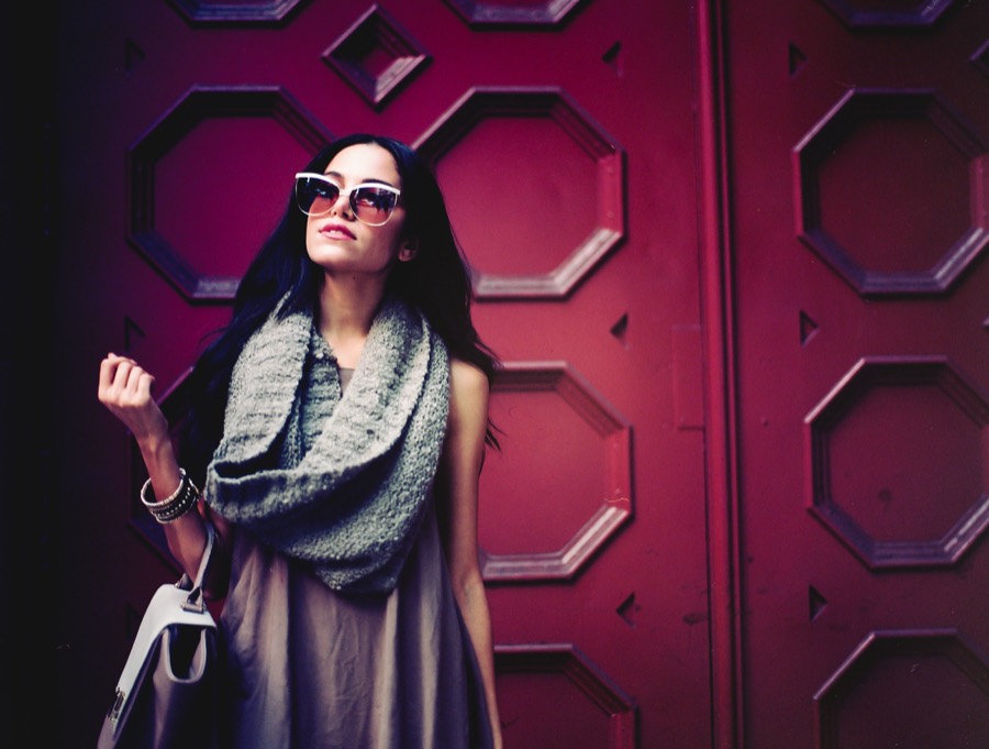 Portrait in sunglasses against a deep red octagonal door