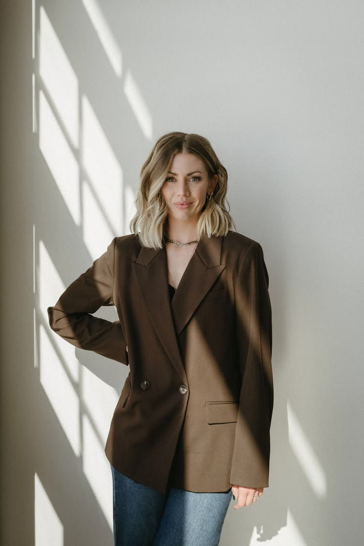 Portrait of a woman in a brown blazer in soft window light